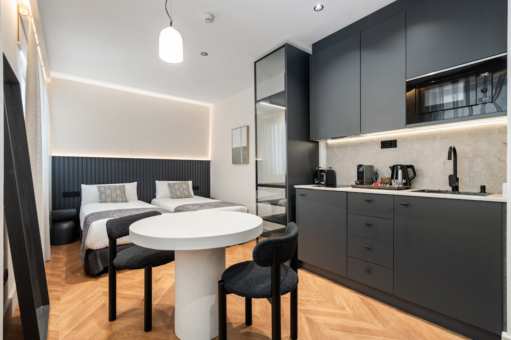 Contemporary two-bedroom suite featuring a spacious lounge and sleek kitchenette.