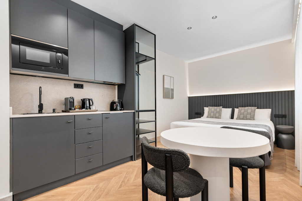 Modern Deluxe Suite with warm wooden floors and a comfortable seating area.