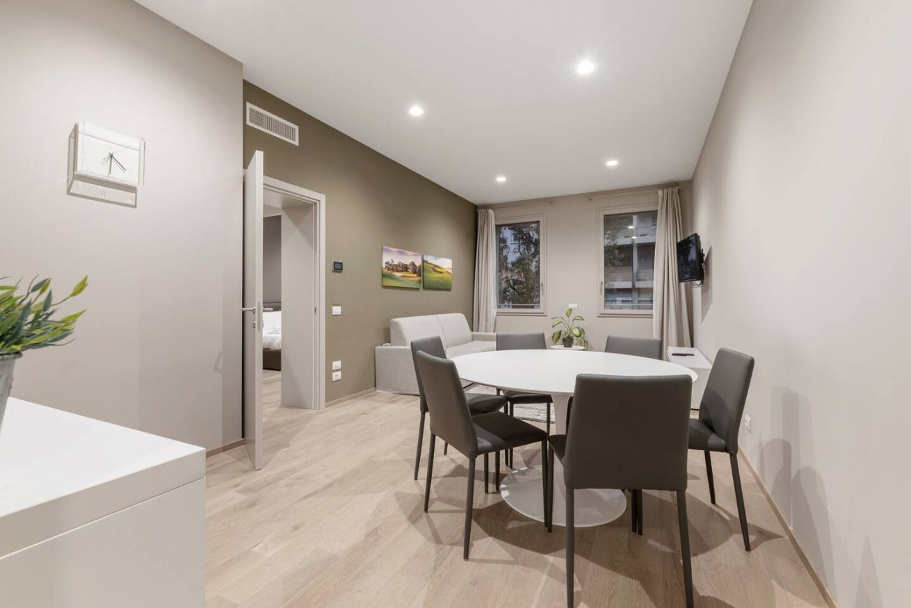 Bright two-bedroom deluxe suite with modern kitchen and stylish living area.