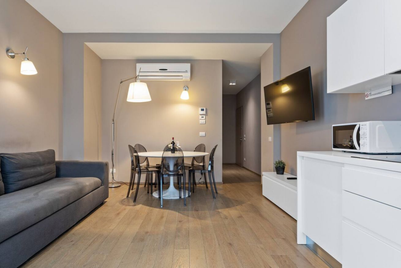 Bright two-bedroom deluxe suite with modern kitchen and stylish living area.
