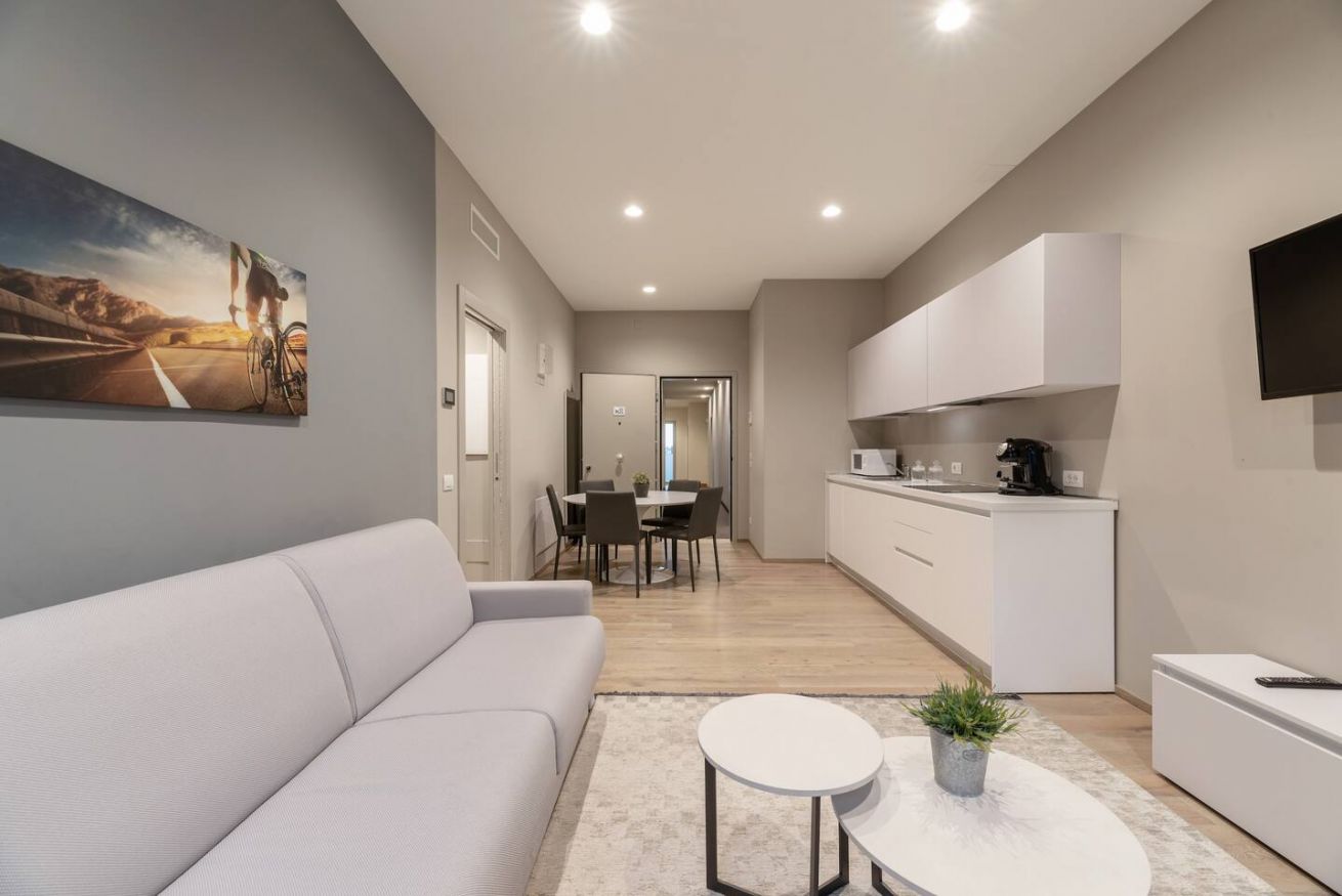 Modern Deluxe Suite with warm wooden floors and a comfortable seating area.