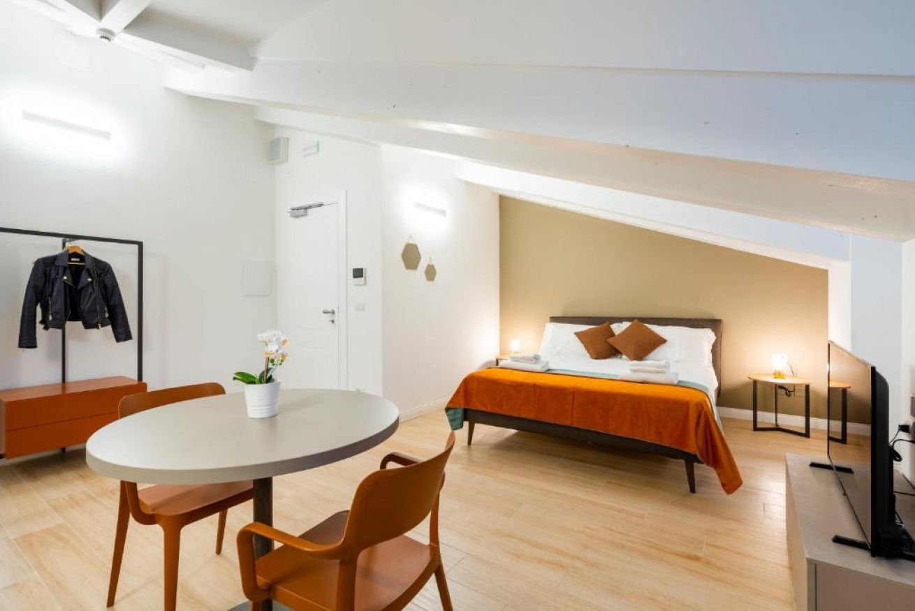 Contemporary Attic Studio with natural light and a comfortable sleeping area.