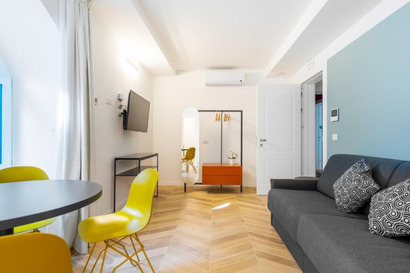 Bright suite with modern kitchen, dining area, and a cozy living space.