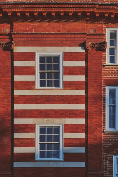 Sophisticated interior hallway with dramatic lighting showcasing blend of exposed brick walls and modern fixtures creating striking architectural contrast