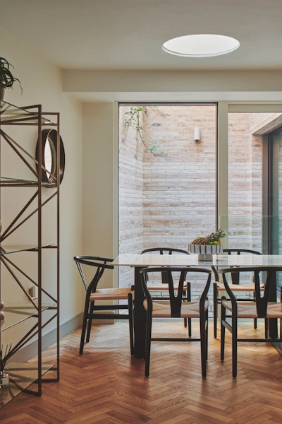 Spacious open-plan luxury apartment with soaring ceilings designer furniture and abundant natural light streaming through large windows creating bright inviting living space